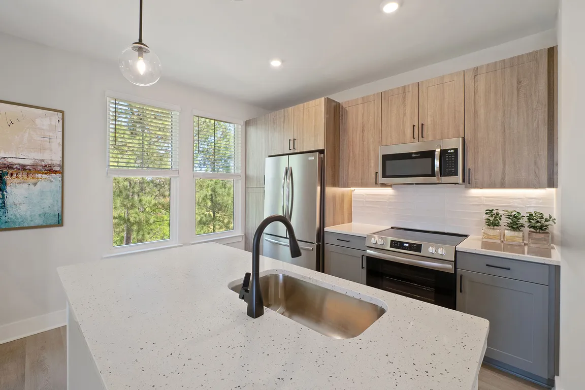 Elegant finishes including luxury vinyl plank flooring, contemporary kitchens, tile backsplash, stainless steel appliances and Quartz countertops