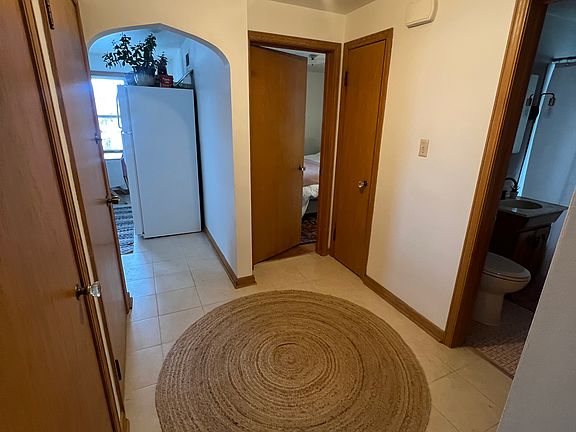 Hallway with 2 coat closets and linen closet