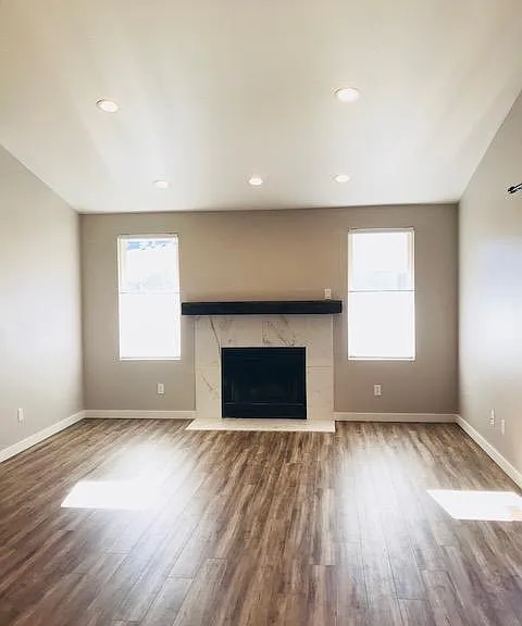 Living room with woodburning fireplace and custom reclaimed mantle