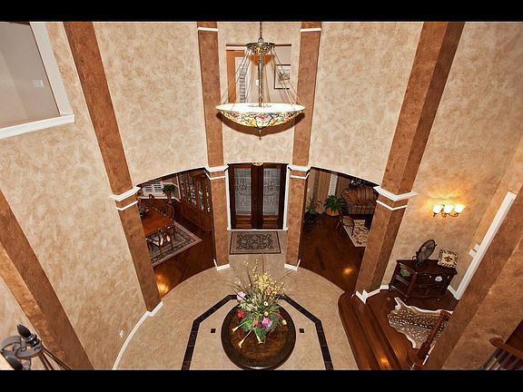As you enter the rotunda, you will notice the attention to detail, from the Quoizel stained glass chandelier, to the inlaid granite on the floor.  Extensive faux painting adds a dramatic effect.
