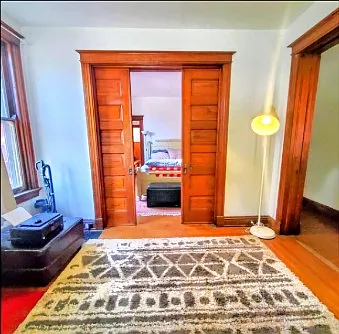 Front parlor/ bedroom, seperated from hallway and bedroom #2 by original pocket doors