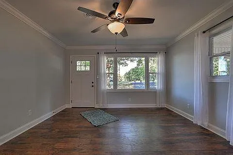 Sunny living room with hardwood flooring.