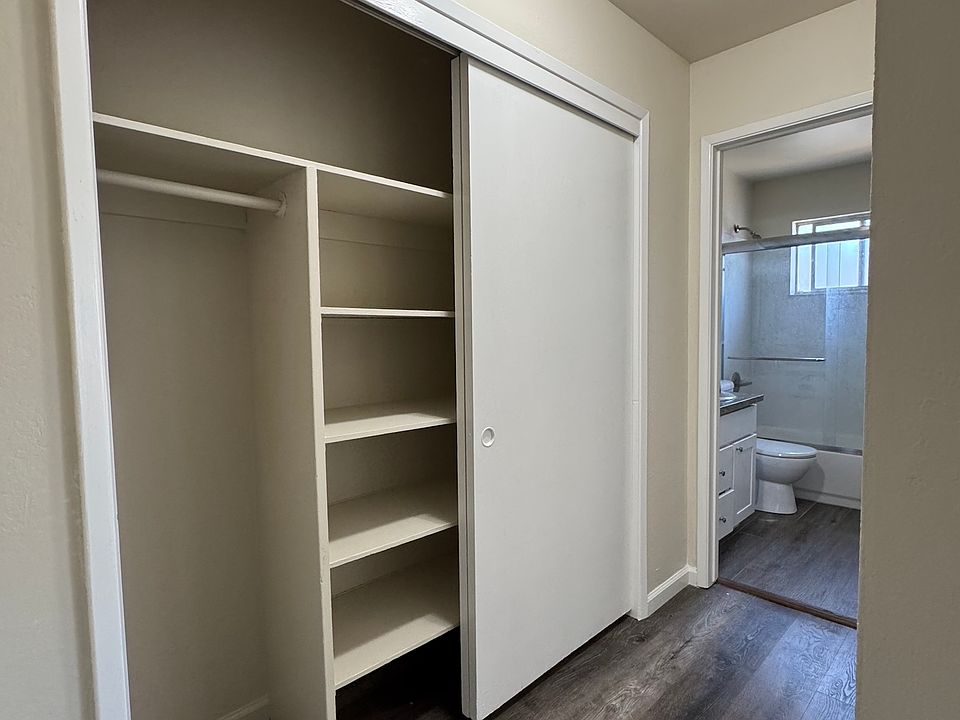 Hallway closet shown open, lots of storage and shelves