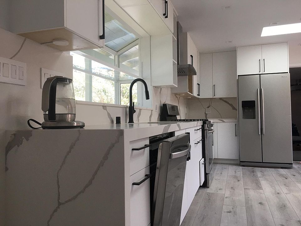 New gourmet euro kitchen with waterfall quartz counter top.