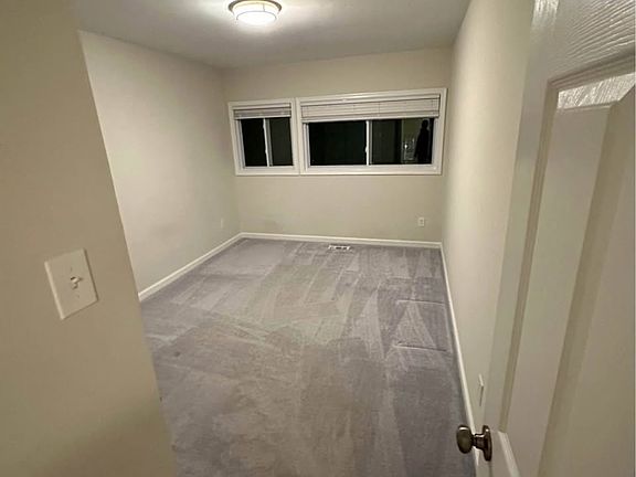 Second bedroom with new carpet and plenty of natural light.