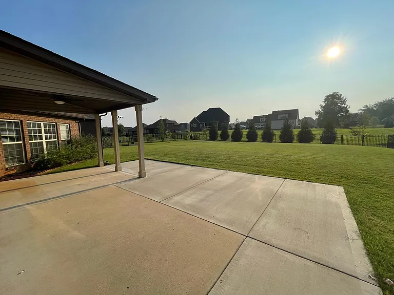 Back patio overlooking a flat, fully fenced yard- ideal for outdoor entertaining and family fun.