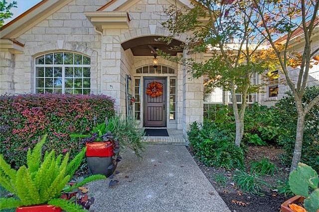 The front landscaping gives the entrance a spa feel, while no grass results in less water usage and less maintenance.