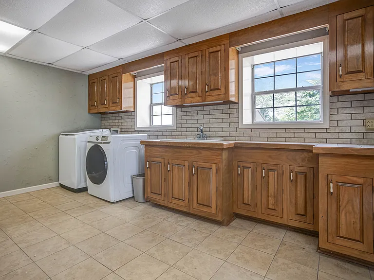 Laundry room is located in another building, across from the house.