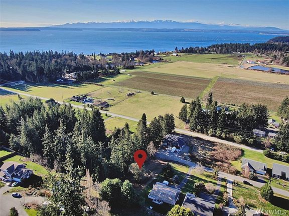 In the distance, Puget Sound, overlooking Mutiny Bay from drone.