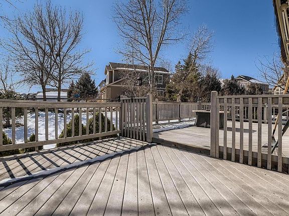Large Multi-level deck with Sunsetter awning. Backyard has mature landscaping and large trees for summer shade.