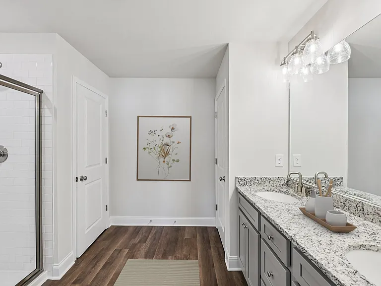 A luxurious primary bathroom with a double vanity and spacious walk-in shower.