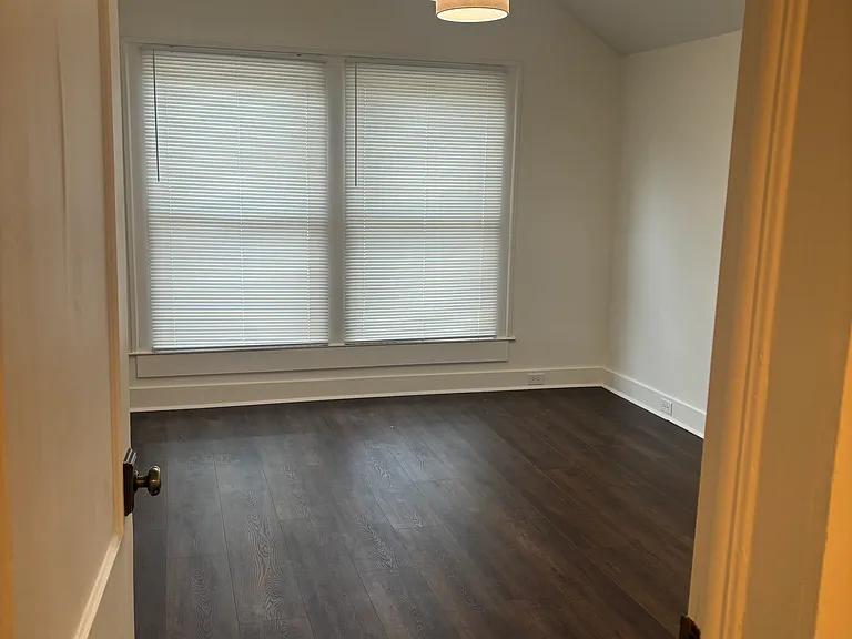 Generous family room with large windows looking over Woodland Ave.