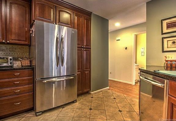 Kitchen boasts custom cherry cabinets, stainless appliances & granite counters!