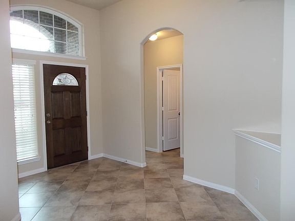 As you are heading out to of your new home to the front yard you will have this amazing view. Gorgeous tile, art notch, beautiful front door.