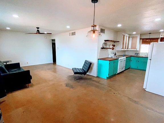 Current view of living, dining into kitchen