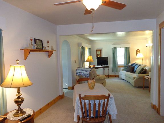 Arched Foyer opens into the  comfortable living room and dining area.
