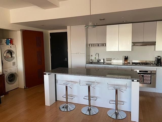 Kitchen showing apartment entrance door and W/D