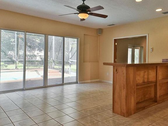 The bar in the _game- room_, sliding glass door to the pool
