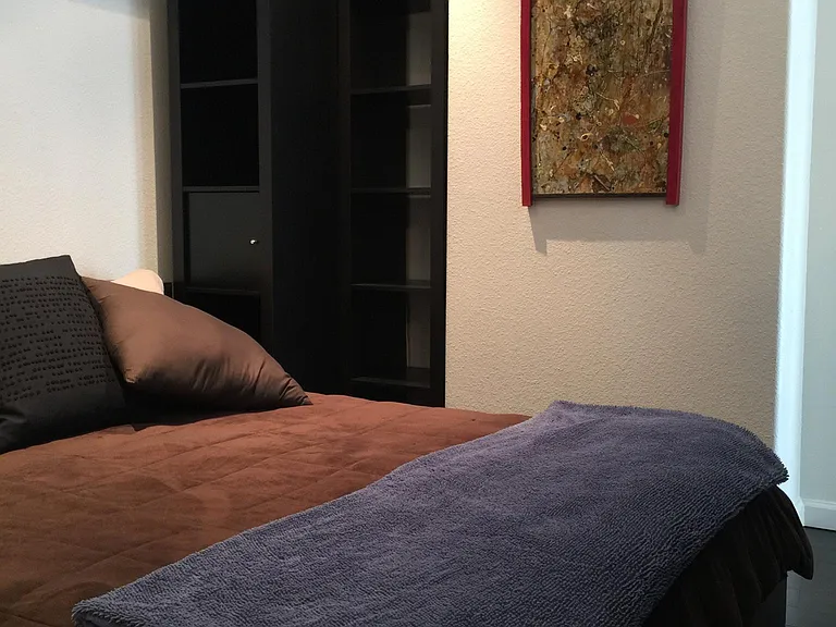 Queen bed with memory foam topper.