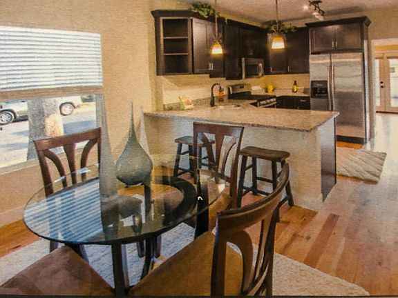 updated kitchen with stainless appliances and granite countertop