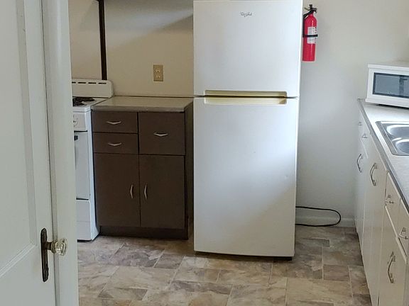 Looking into kitchen from living room. Good view of new flooring in kitchen.