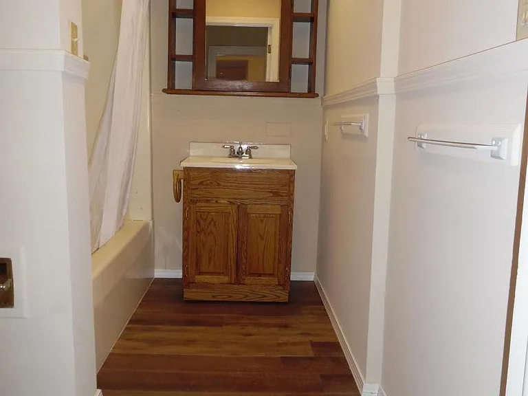 Main bathroom, stool is walled off on the left at the front , tub/shower behind that, vanity straight ahead