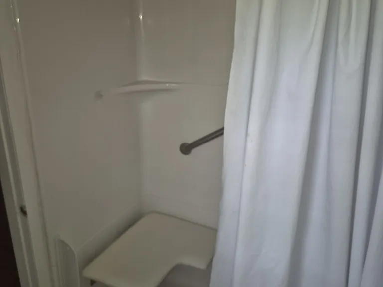Shower seat in bedroom bathroom