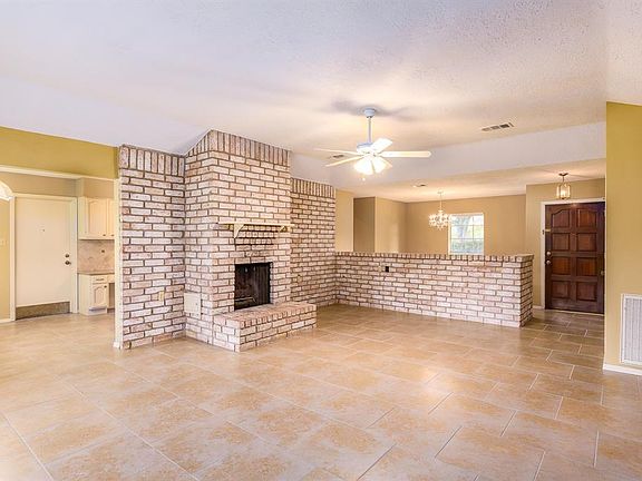The den offers great space with the fireplace as a nice focal point. Tile flooring through this area is easy to keep and neutral colors as well.