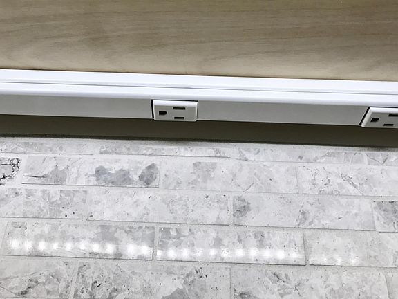 Outlets and lighting located under counter. Outlets & lights everywhere.