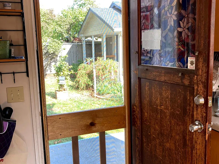 Back door out from the kitchen area - seen here is the cottage. It is separated from the house and house yard by a fenced in area that is just for the cottage tenants. They enter and exit the property through a back gate.