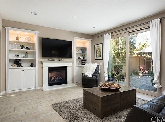 Cozy Fireplace and Custom book shelving in Great Room