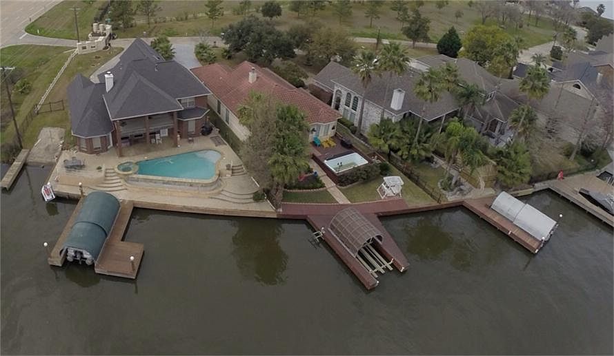 Lake front home is complete with your own private boat ramp, pool, and dock.