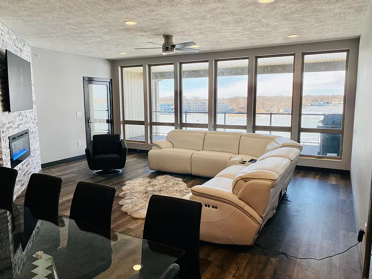 Living room; 3 recliners with stone electric fireplace and flatscreen TV