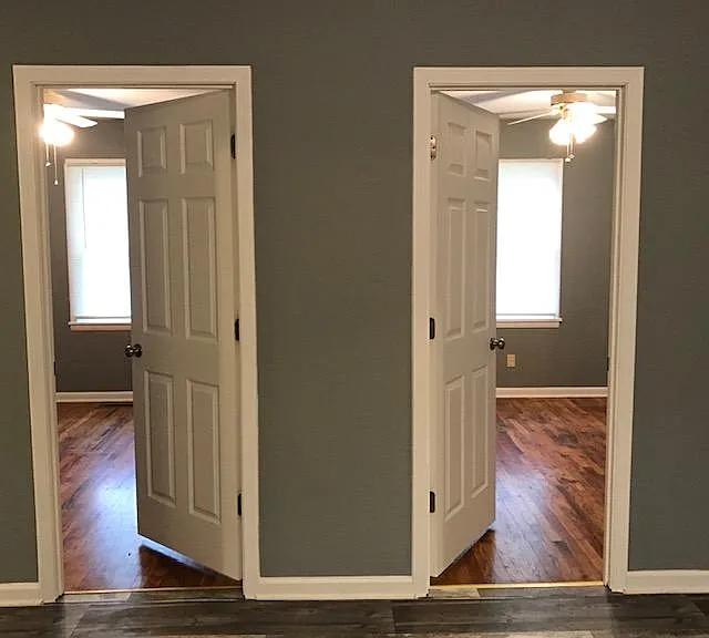 Doorway to bedroom 1 on left. Bedroom 2 on right. Hardwood floors. New panel doors though out.