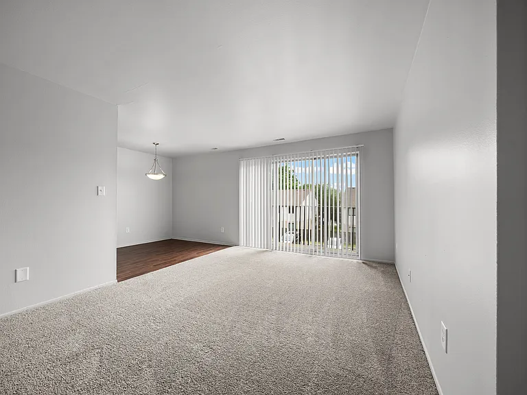 Open and airy living room with natural lighting at Knottingham Apartments in Clinton Township, MI.