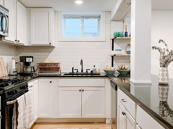 kitchen with granite counters + stainless steel appliances