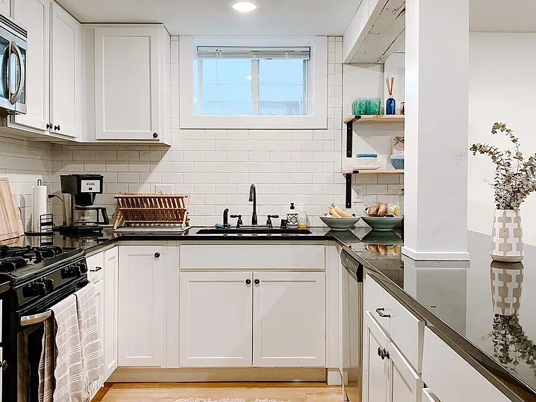 kitchen with granite counters + stainless steel appliances