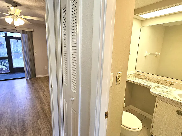Hallway to 1/2 bath & bedroom