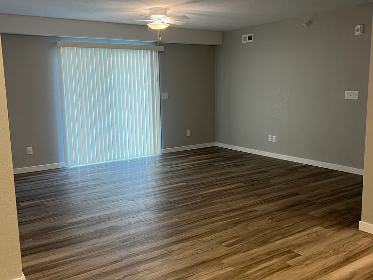 View of living area from kitchen showing sliding glass door