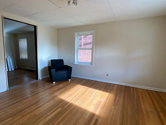 Living room has a new cozy sectional (see 330 Susq), end & coffee tables, and TV media stand.
