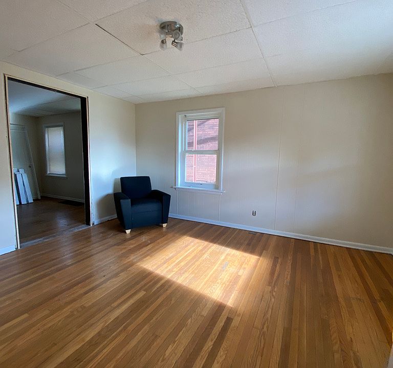 Living room has a new cozy sectional (see 330 Susq), end & coffee tables, and TV media stand.