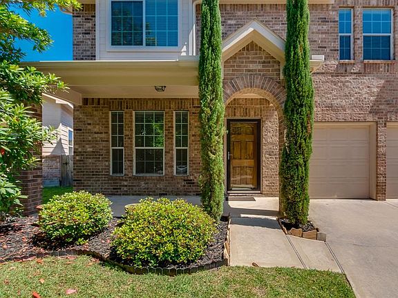 Mature landscaping highlights the yard front and back.