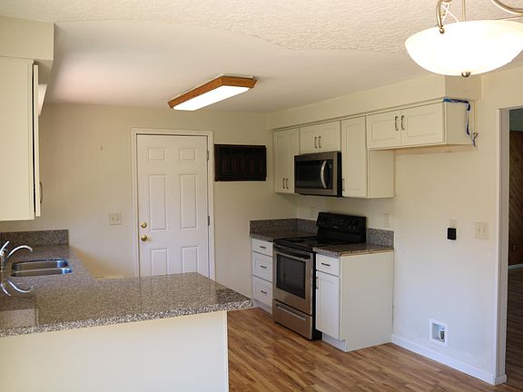 Kitchen comes with refrigerator, range, microwave, and dishwasher.
