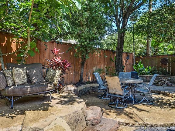 Back yard also features fire pit with multiple seating areas.