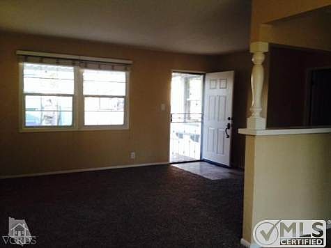 Sunny, carpeted Living Room