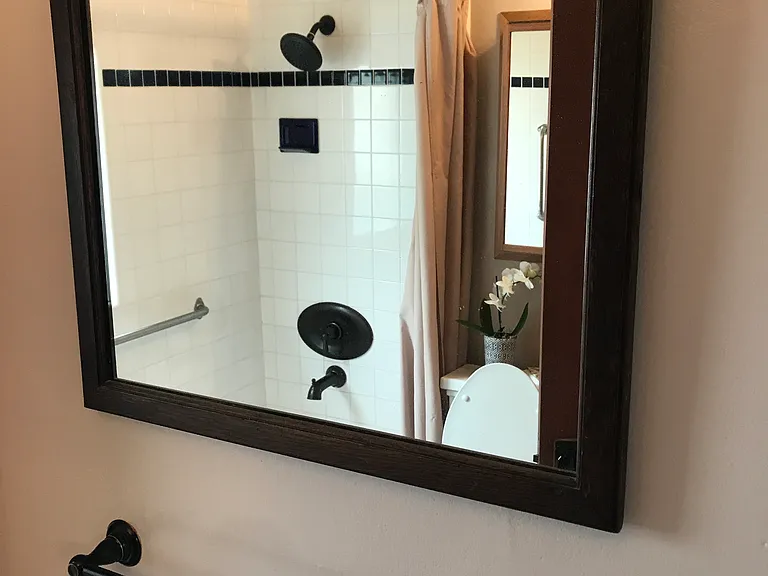 Bathroom Photo showing mirror, towel bar, shower/tub in reflection.