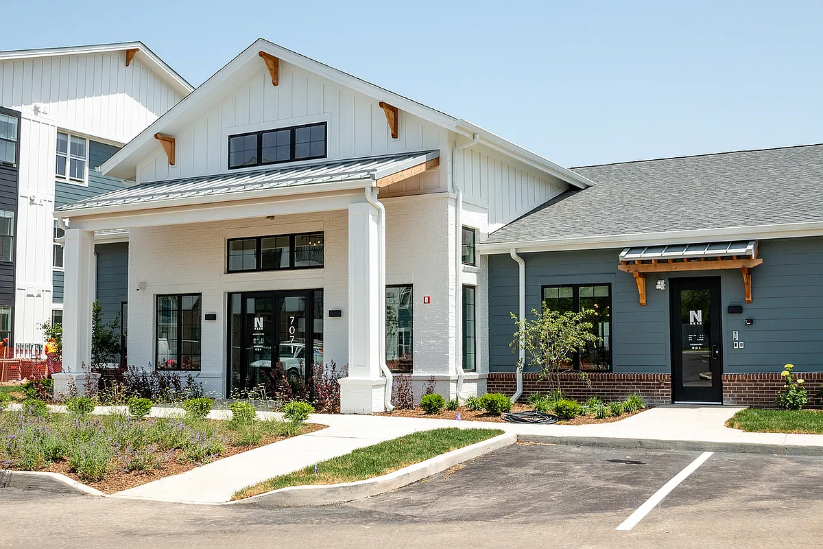 The Nese Apartments clubhouse includes the Leasing Office, resident lounge and game room, package center, conference room,WFH stations, a coffee bar. and fitness center. - Nese Apartments