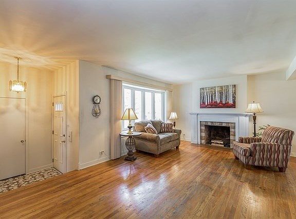 Tile Floor in Foyer, Spacious Living Room with Beautiful Fireplace