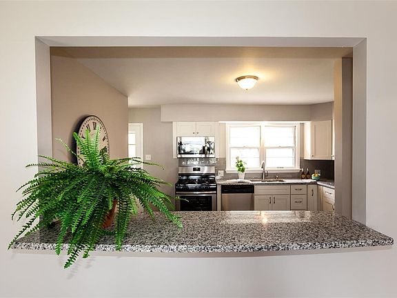 Gorgeous granite breakfast bar opens to the kitchen.