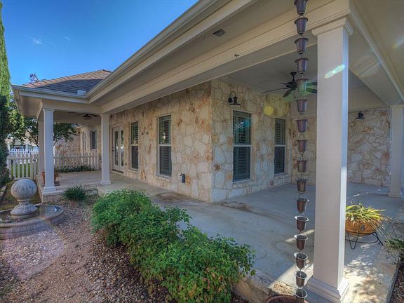Covered Patio along the side and front of house & Front Patio